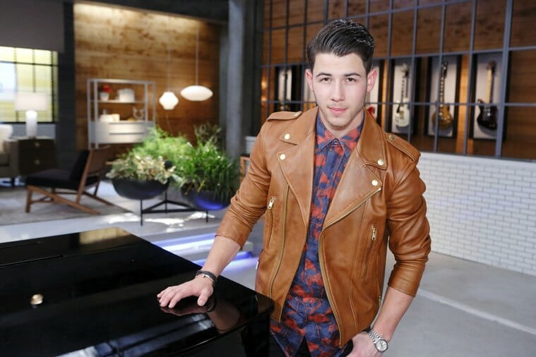 Nick Jonas wearing his Rolex Datejust II on the set of the The Voice